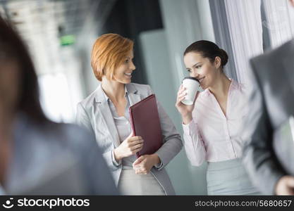 Businesswomen walking in office corridor