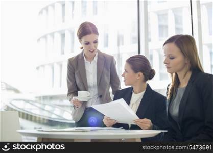 Businesswomen with paperwork during coffee break