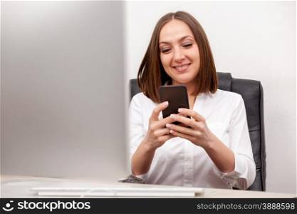 Businneswoman is writing an email from her mobile phone in office