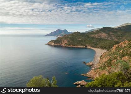 Bussaglia beach and distant mountains near Porto on west coast of Corsica
