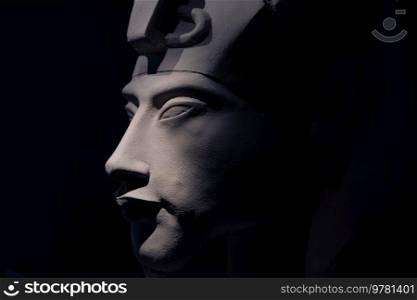 bust of pharaoh Echnaton  Akhenaten, aka Amenhotep IV  around black background . cloes up