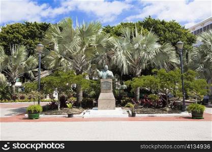 Bust on a pedestal in front of trees, Sir Milo Boughton Butler, Rawson Square, Nassau, Bahamas