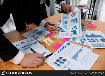 Busy analyst team discuss financial data on digital dashboard, plan goal and brainstorm idea with sticky note. Utilizing business intelligence and Fintech technology concept. Fervent. Busy analyst team discuss financial data on dashboard with post note. Fervent