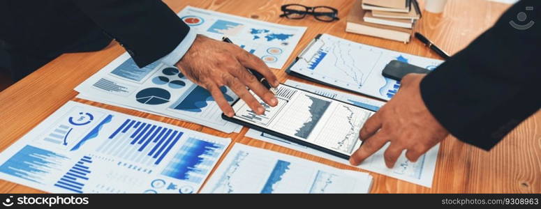 Busy analyst team discussing financial data on digital dashboard, analyzing chart and graph using data science software display on a tablet screen. Business intelligence and Fintech. Fervent. Busy analyst team discussing financial data on tablet. Fervent