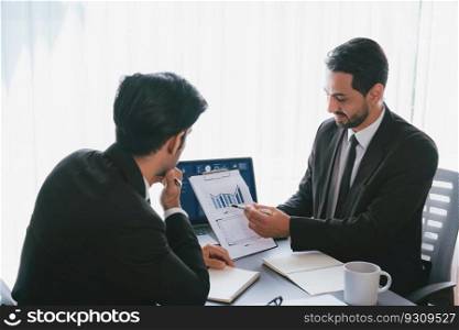 Busy analyst team discussing financial data on digital dashboard, analyzing chart and graph using data science software display on a laptop screen. Business intelligence and Fintech. Fervent. Busy analyst team discussing financial data on laptop. Fervent