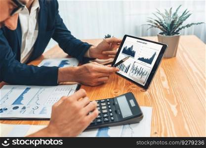 Busy analyst team in office analyzing financial data analysis for marketing strategy in workspace using BI dashboard with graph and chart on tablet screen to improve business performance. Entity. Busy analyst team in office analyzing financial data analysis by tablet. Entity