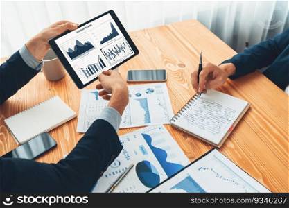 Busy analyst team in office analyzing financial data analysis for marketing strategy in workspace using BI dashboard with graph and chart on tablet screen to improve business performance. Entity. Busy analyst team in office analyzing financial data analysis by tablet. Entity