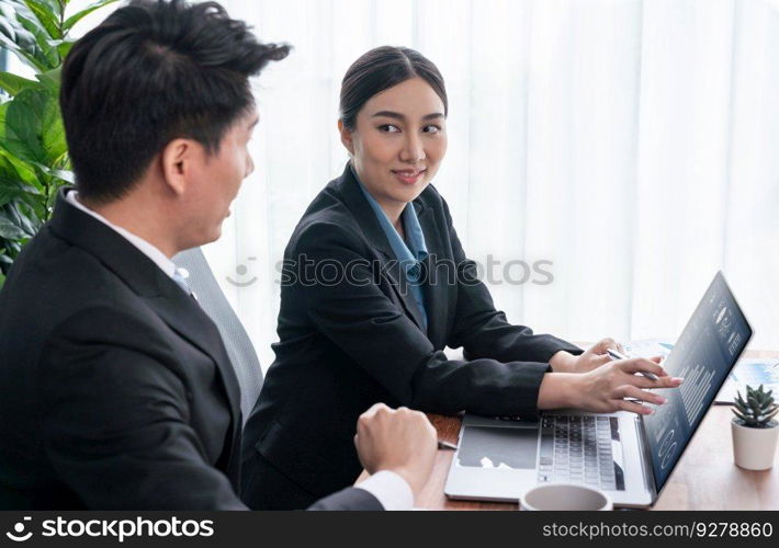 Busy analyst team in office discuss data analysis and marketing strategy using BI dashboard and statistics on laptop screen to improve business performance at meeting with strong teamwork. Jubilant. Busy analyst team in office discuss data analysis and marketing. Jubilant