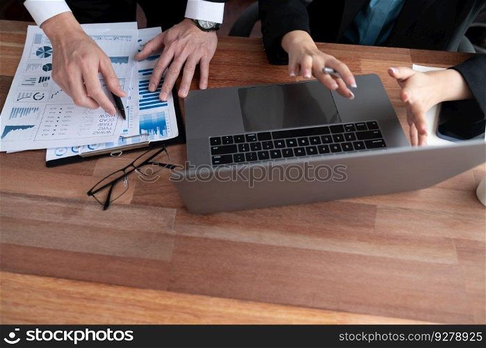 Busy analyst team in office discuss data analysis and marketing strategy using BI dashboard and statistics on laptop screen to improve business performance at meeting with strong teamwork. Jubilant. Busy analyst team in office discuss data analysis and marketing. Jubilant