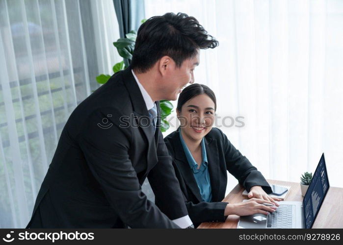 Busy analyst team in office discuss data analysis and marketing strategy using BI dashboard and statistics on laptop screen to improve business performance at meeting with strong teamwork. Jubilant. Busy analyst team in office discuss data analysis and marketing. Jubilant