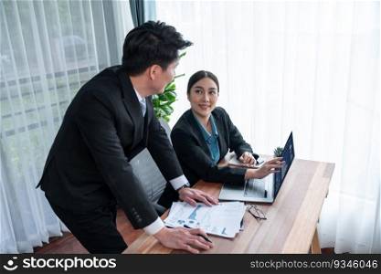 Busy analyst team in office discuss data analysis and marketing strategy using BI dashboard and statistics on laptop screen to improve business performance at meeting with strong teamwork. Jubilant. Busy analyst team in office discuss data analysis and marketing. Jubilant