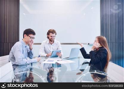 Busy business people meeting in a meeting room, Multitask Teamwo. Busy business people meeting in a meeting room, Multitask Teamwork Activity. Busy business people meeting in a meeting room, Multitask Teamwork Activity