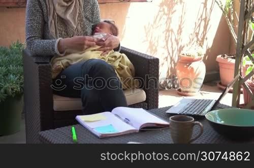 Busy business woman and newborn baby, happy multitasking mom working with infant, mother holding son at home, talking on the phone, manager on telephone. Child sleeping, taking nap. Family, maternity