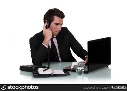 Busy businessman sat at desk