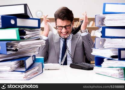 Busy businessman under stress due to excessive work