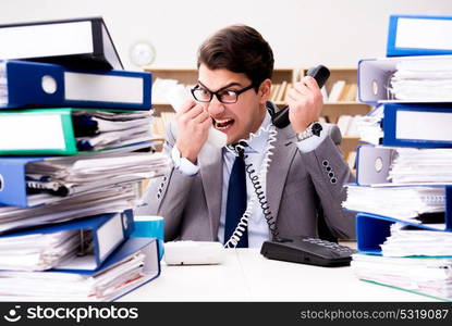 Busy businessman under stress due to excessive work