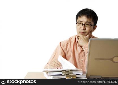 Busy businessman with laptop and a stack of paper