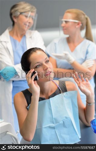 Busy businesswoman patient calling phone at dentist office doctor waiting