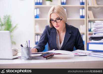 Busy businesswoman working in office at desk