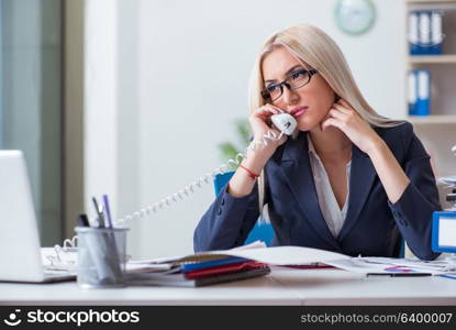 Busy businesswoman working in office at desk