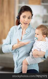 busy businesswoman working with baby on lap