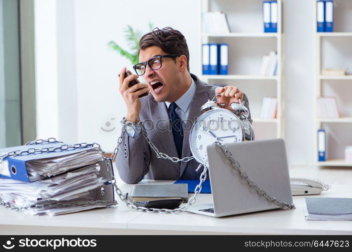 Busy employee chained to his office desk