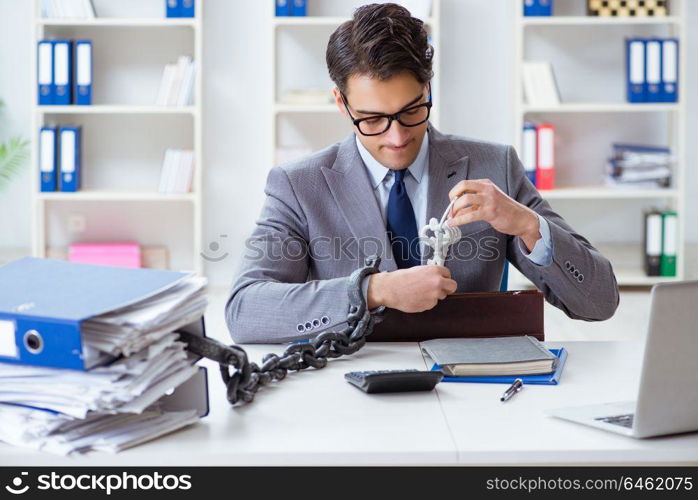 Busy employee chained to his office desk