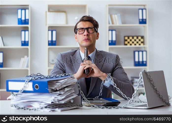 Busy employee chained to his office desk