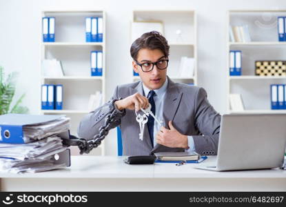 Busy employee chained to his office desk