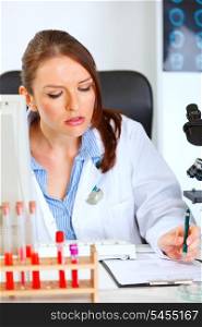 Busy female medical doctor working at office&#xA;
