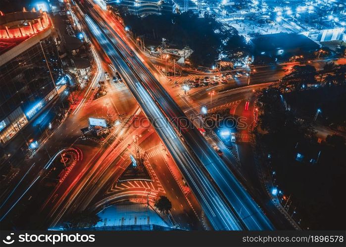 Busy highway road junction in metropolis city center at night . Transportation and infrastructure concept .. Busy highway road junction in metropolis city center at night