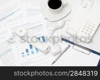 Busy office desk telephone on paper charts business meeting