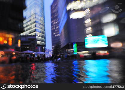 busy traffic scene of street in night with car traffic and vivid colored city scene