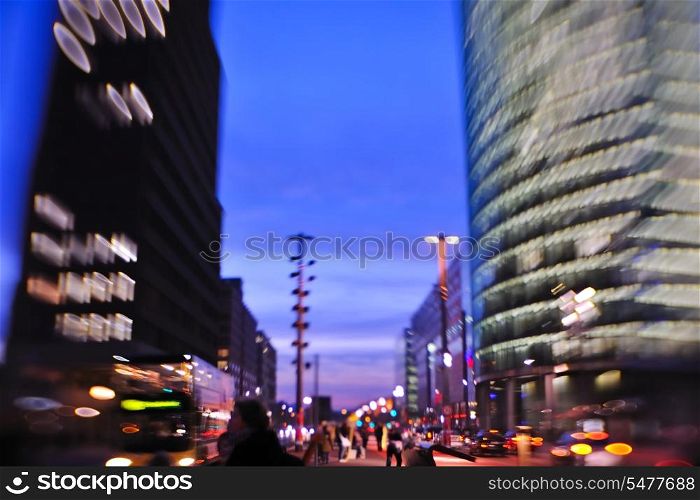 busy traffic scene of street in night with car traffic and vivid colored city scene