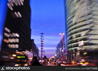 busy traffic scene of street in night with car traffic and vivid colored city scene