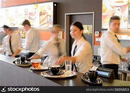 Busy waiter and waitresses working at bar night