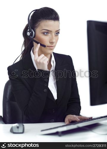 Busy woman seriously hearing the customer talk in headset over white background