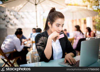 Busy young business woman working on desk using laptop in coffee shop