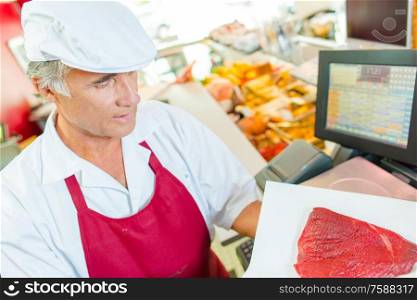 Butcher at work in his shop