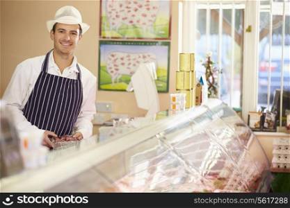 Butcher At Work In Shop