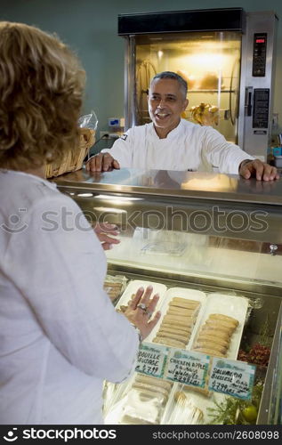 Butcher attending to customer