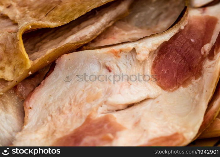 Butcher cutting little pieces of fat pork meat