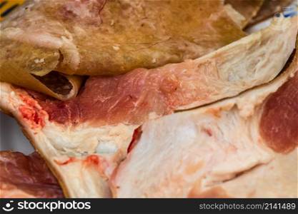 Butcher cutting little pieces of fat pork meat