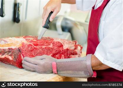 Butcher cutting up beef
