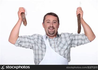 butcher holding fresh sausages