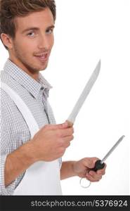 Butcher holding knifes