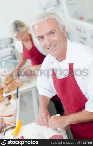 Butcher serving a female customer