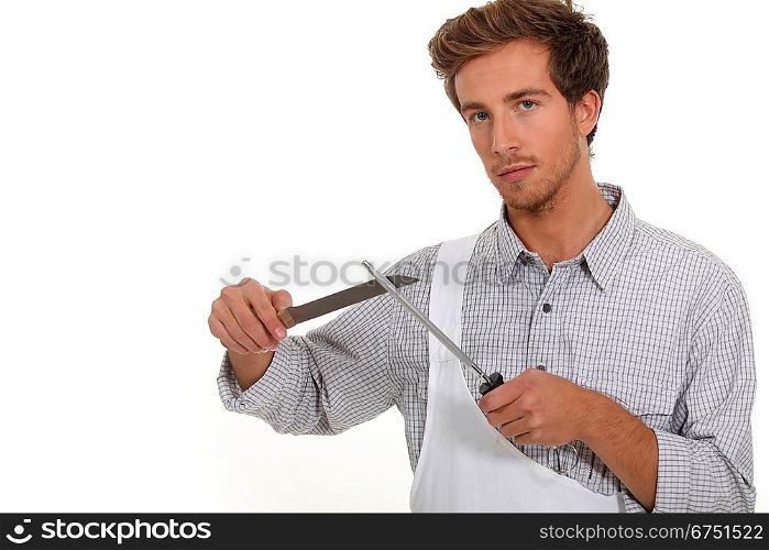 Butcher sharpening a knife