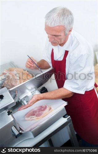 Butcher slicing ham