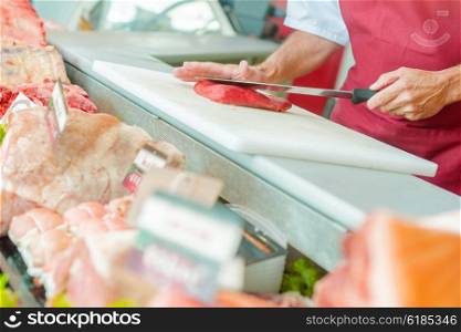 Butcher slicing steak